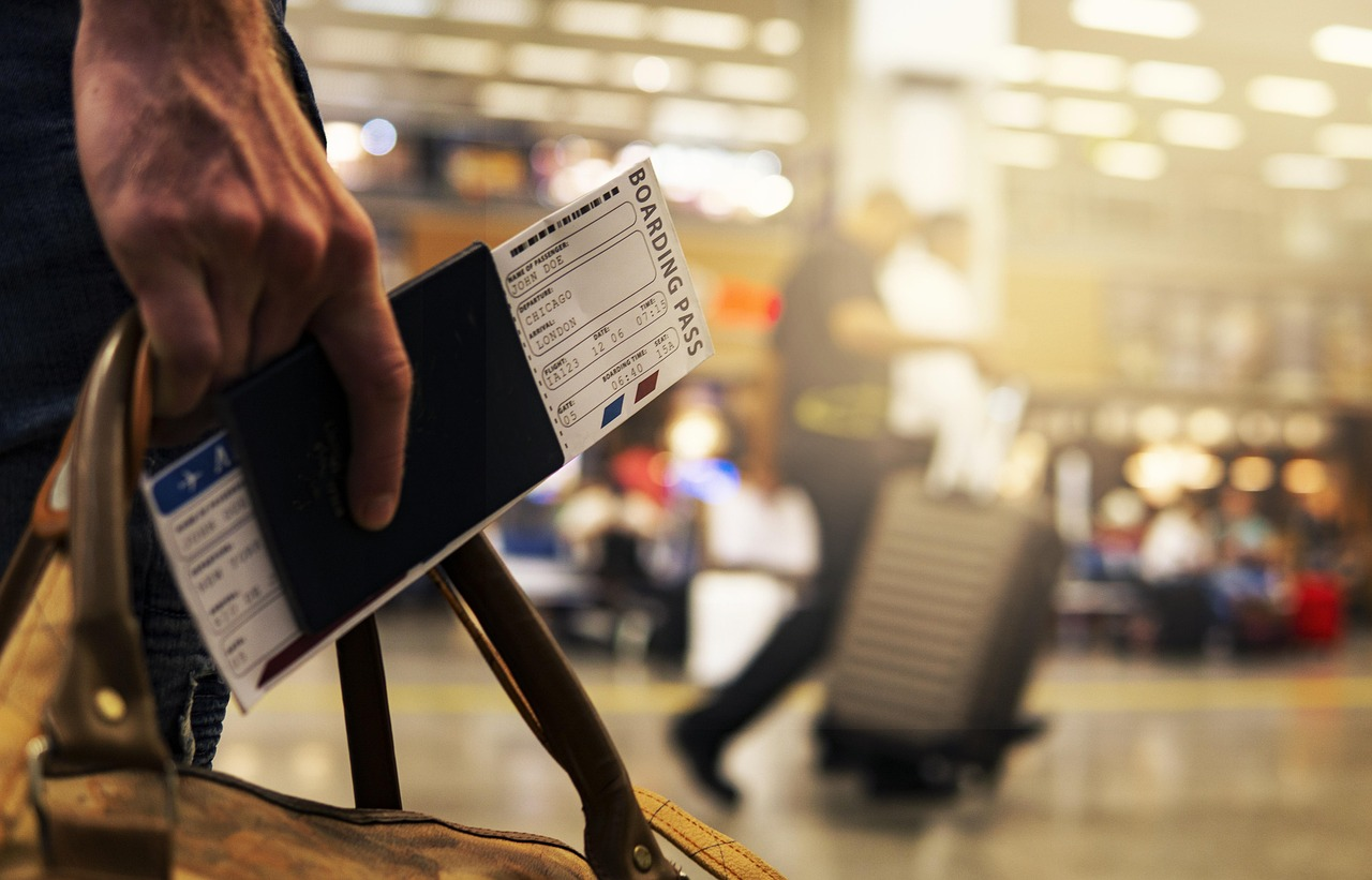 man holding travel documents