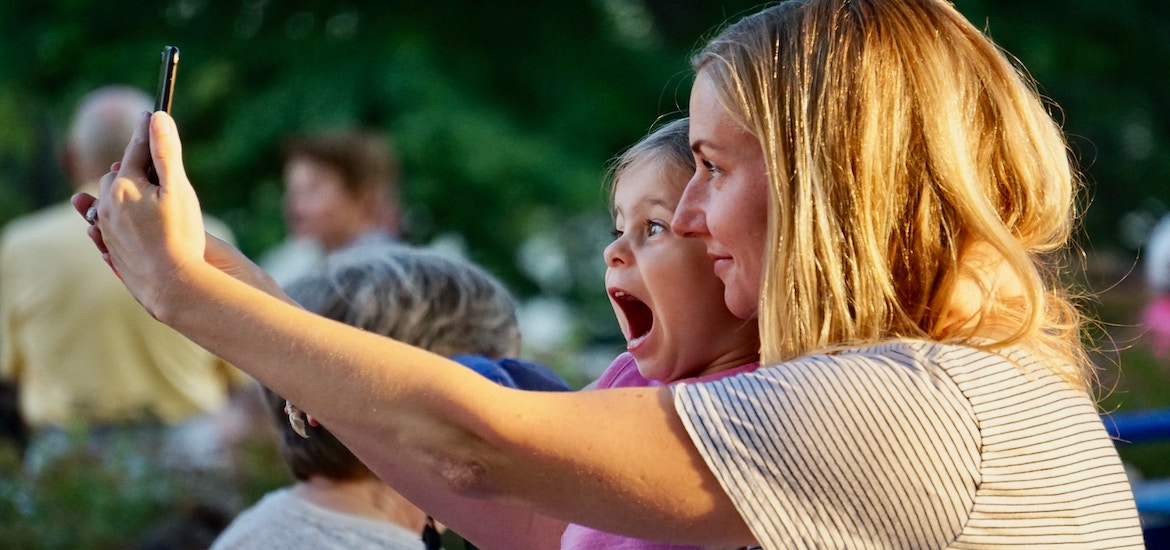 mum and daughter take selfie at concert