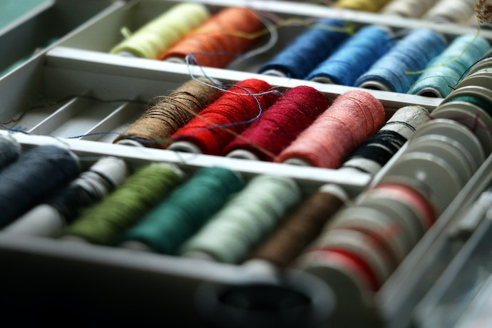 a selection of sewing equipment and threads