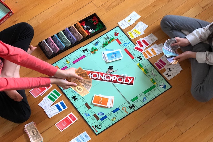 two children play monopoly