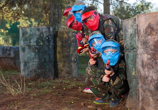 Kids of all ages having fun playing paintball