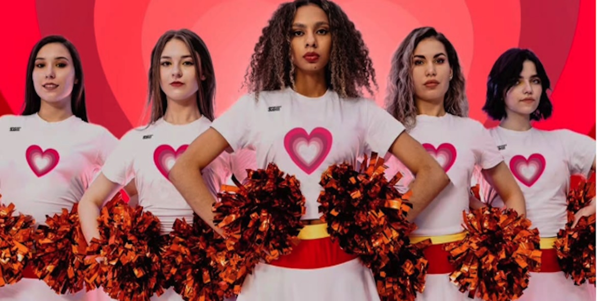 Cheerleaders in heart uniforms holding pom-poms