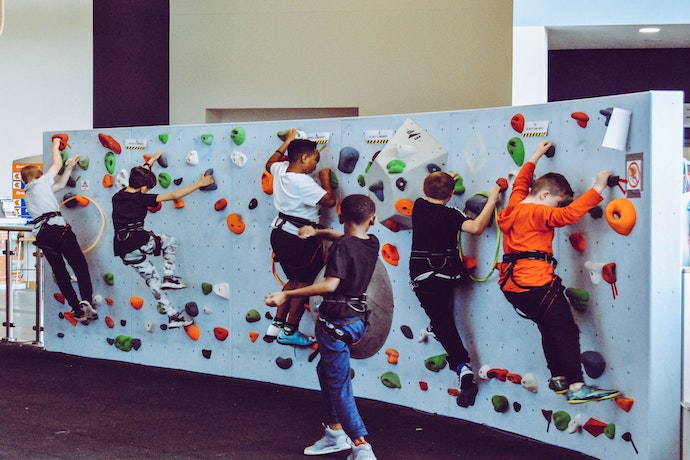 children enjoy indoor rock climbing