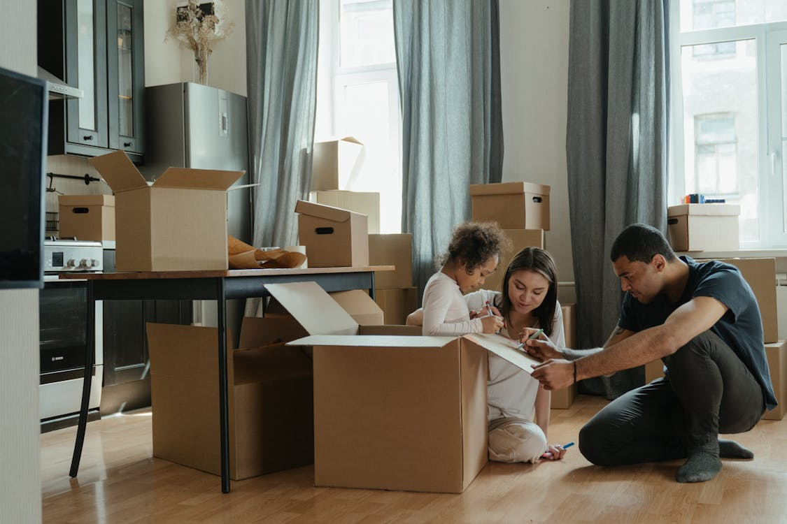 a family packing boxes to move home