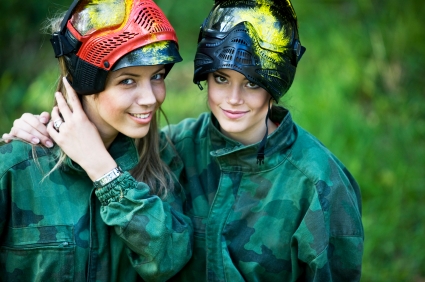 Two girls all geared up and ready to play paintball
