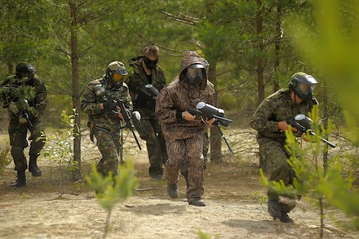 A group of paintball players running to their next location