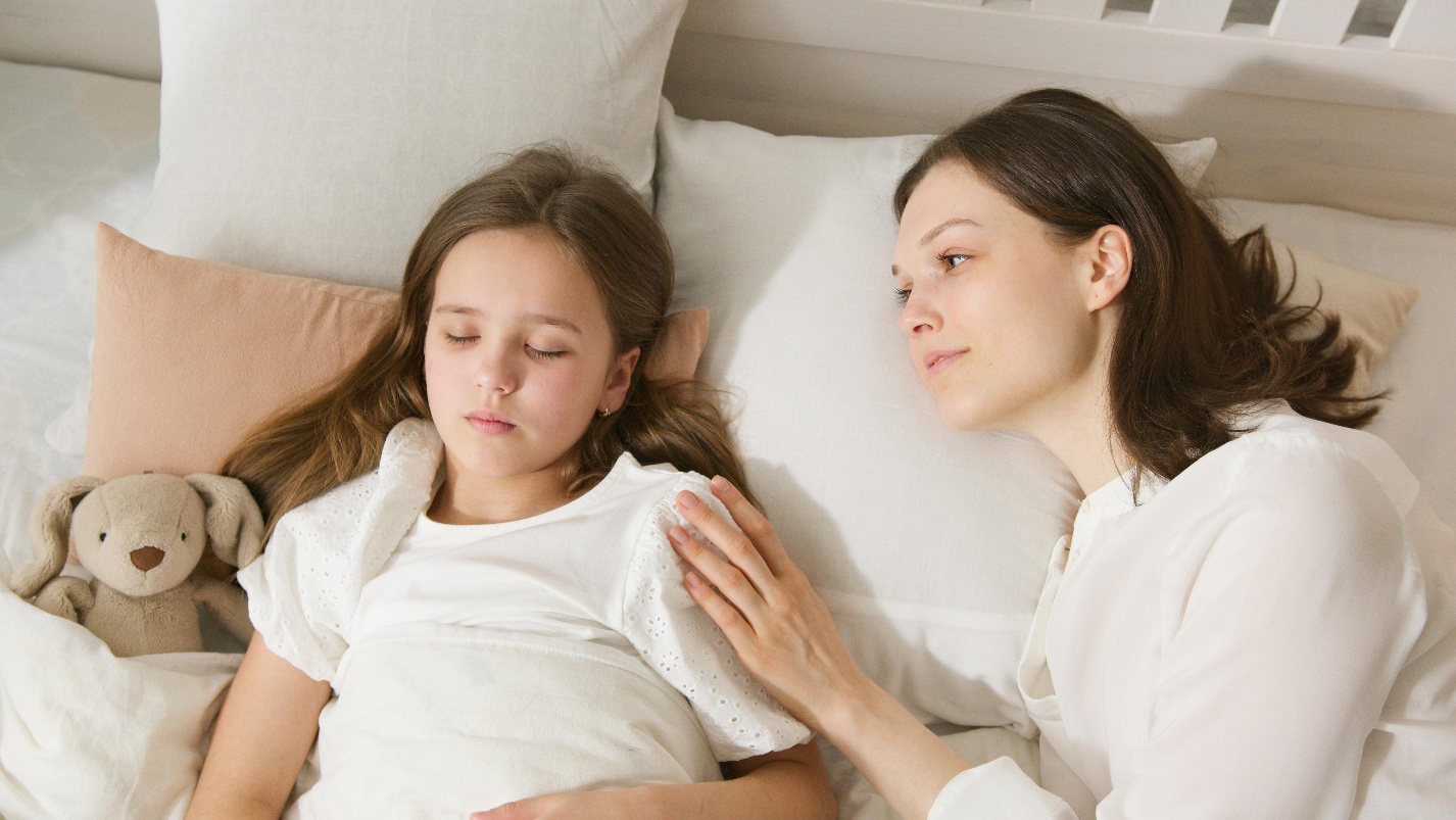 Sleeping daughter with mum