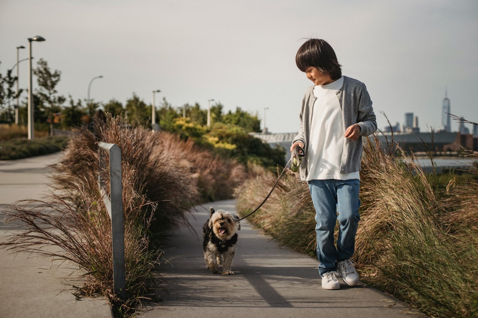 young boy walking do by beach
