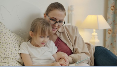 a mum and daughter learning on computer