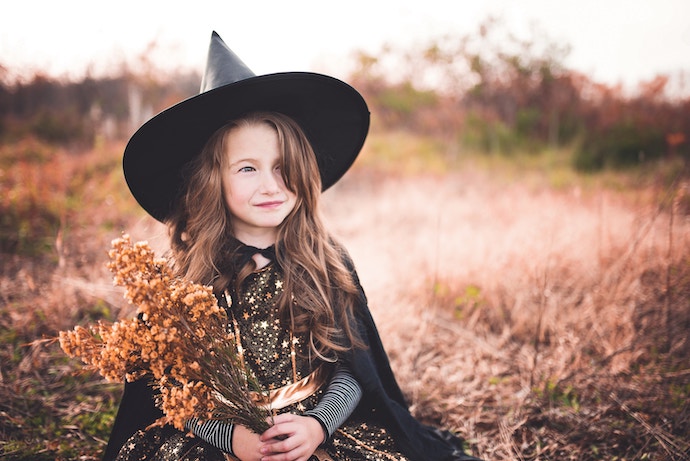 a young girl dressed as a witch for Halloween