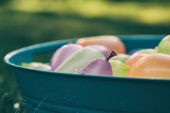 a bucket of water balloons filled and ready
