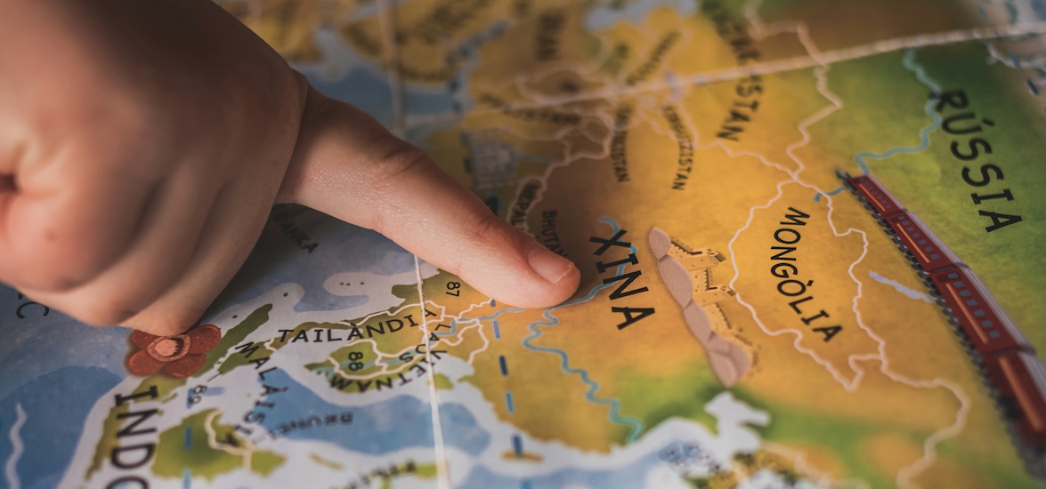 A kids finger on a map