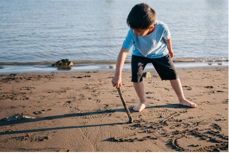 kid playing in sand