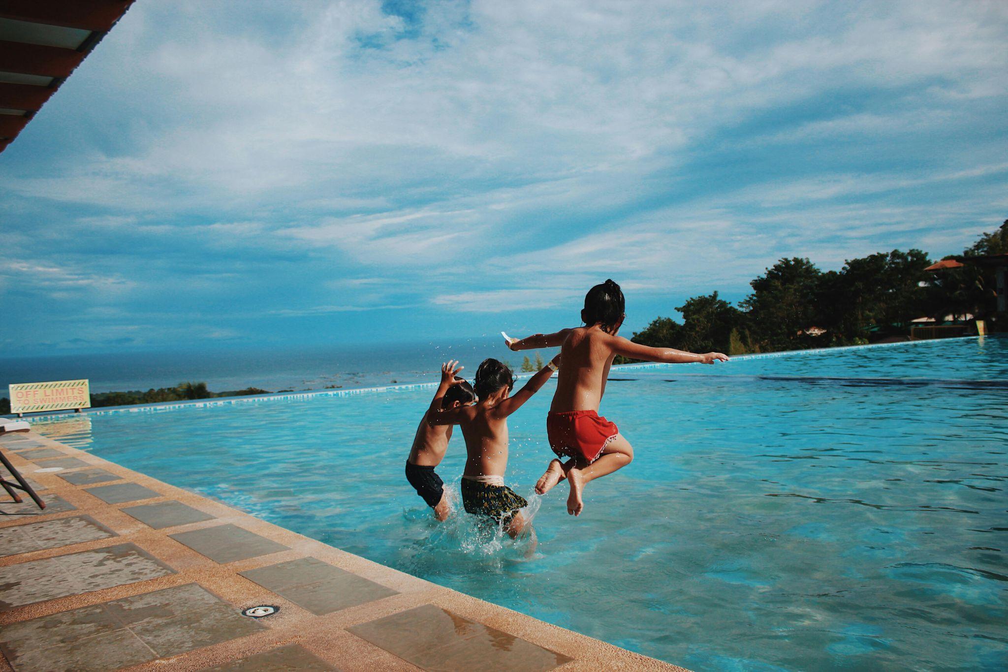 three bioys jump in the pool