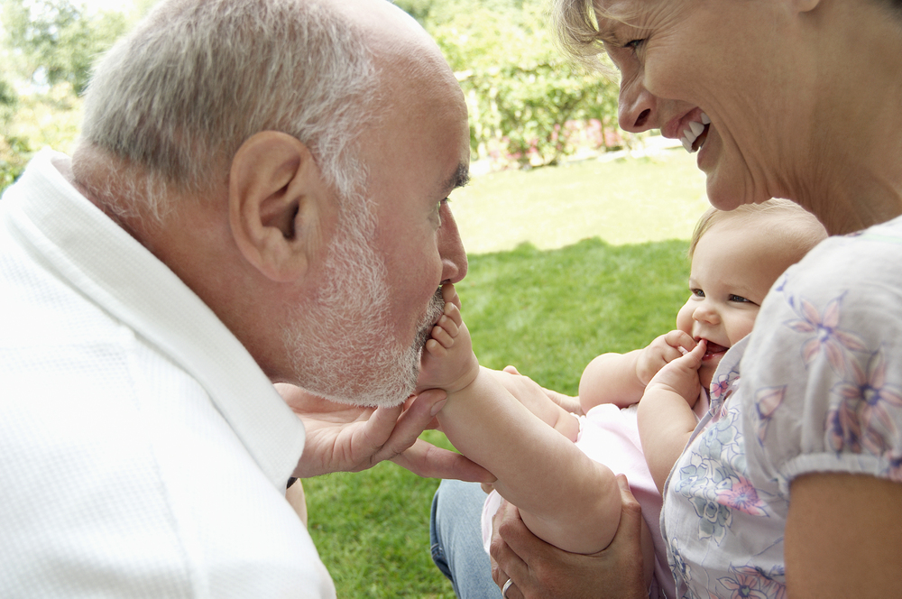 grandad kisses baby foot
