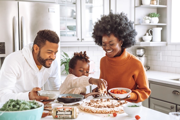 a happy family make a pizza together