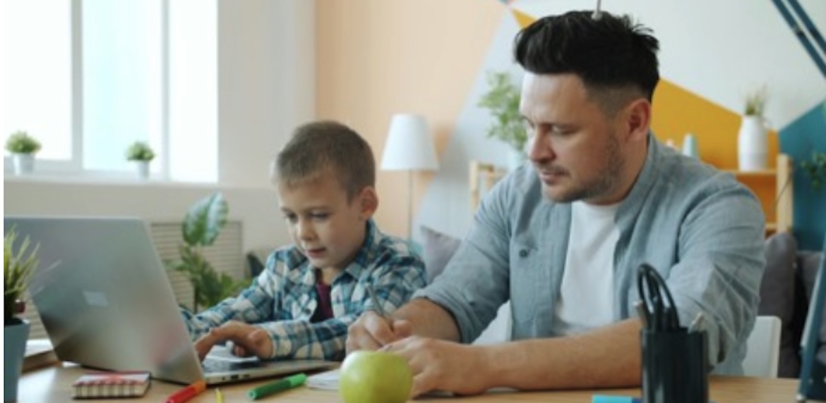 father and son leanring at computer