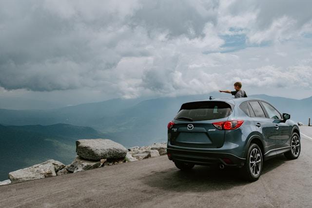 kid staring out of car into the landscape