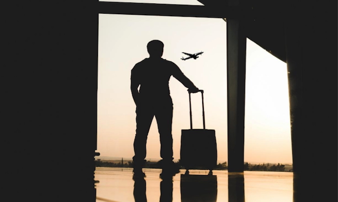 a man with travel case at airport