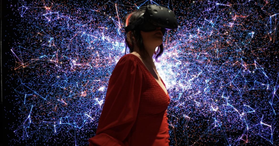 Woman in a red dress exploring a VR museum