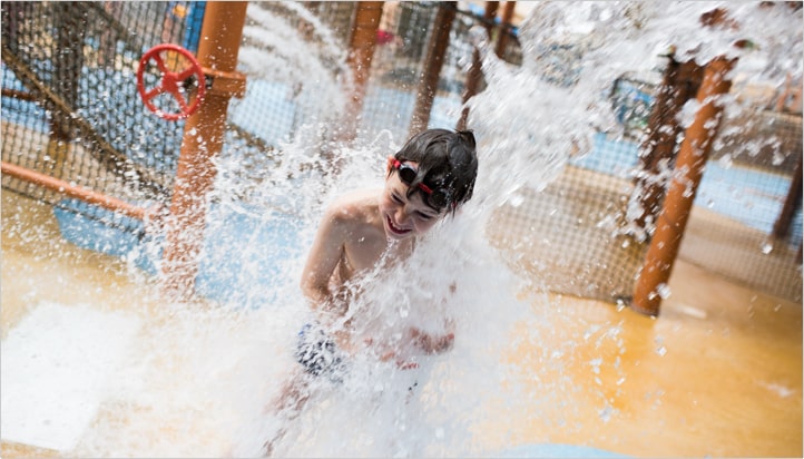 alton towers water park kid getting wet from the ride