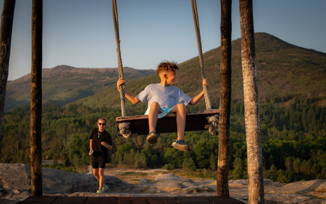 A kid enjoying the swing outdoors