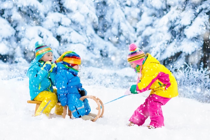 small children play on a sledge