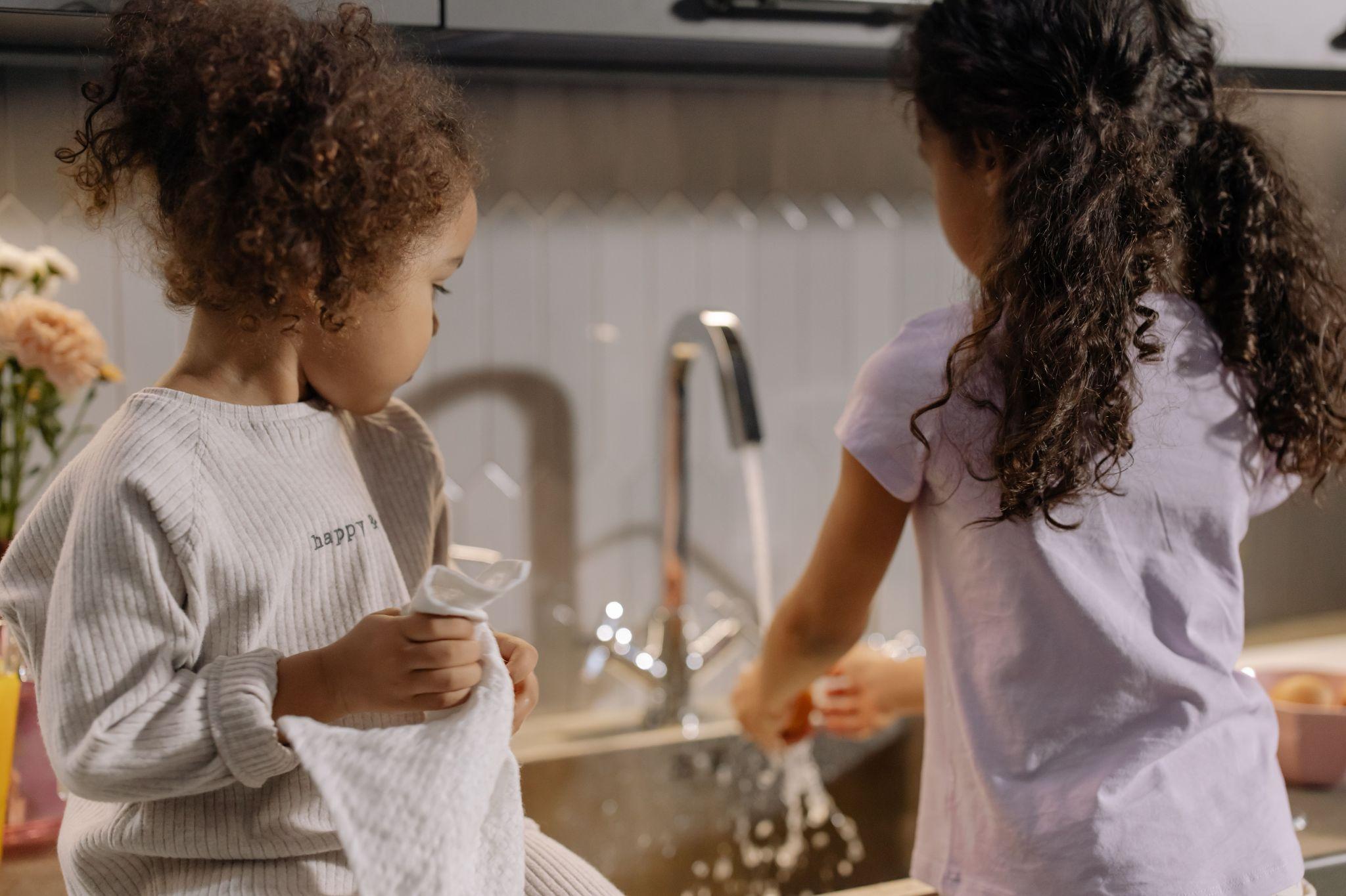 kids helping to wash up dishes