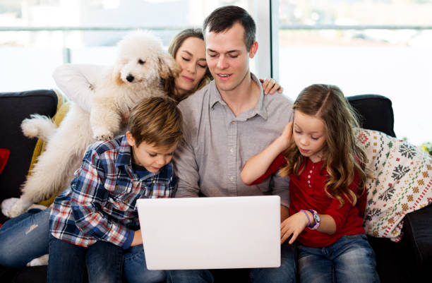 family with dog on laptop