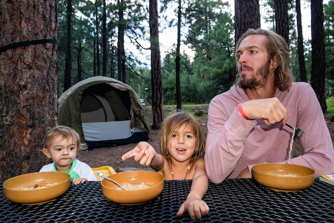 family camping eating meal
