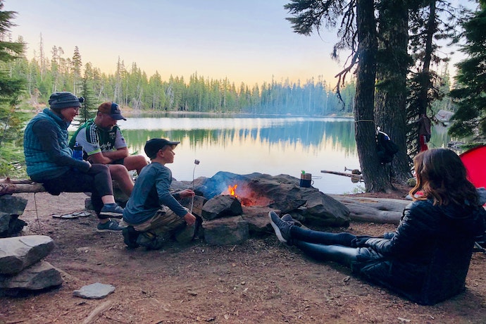A family camping near a beautiful lake