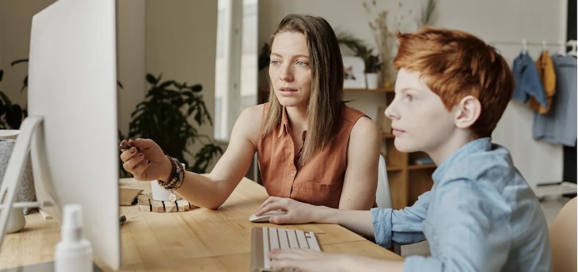 mum teaching son on computer