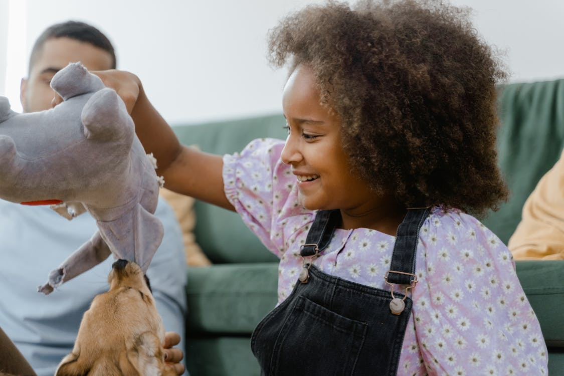 girl playing with dog