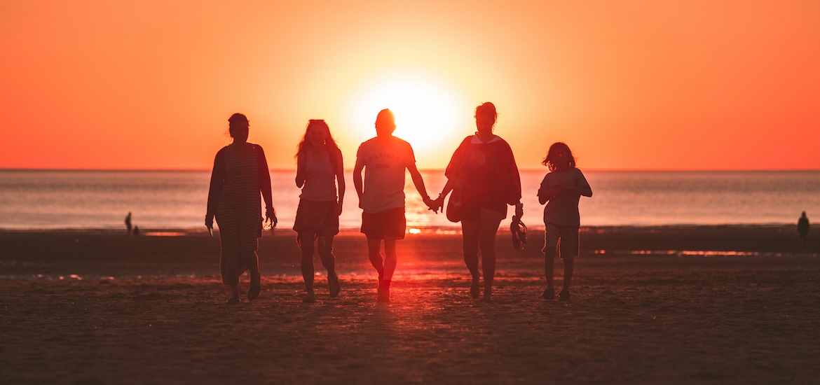 family at sunset on beach