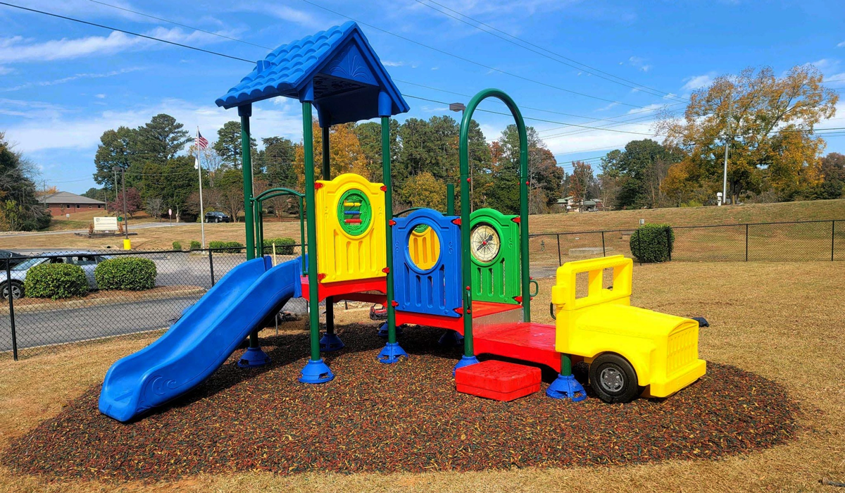 Colorful preschool playground with slide and truck