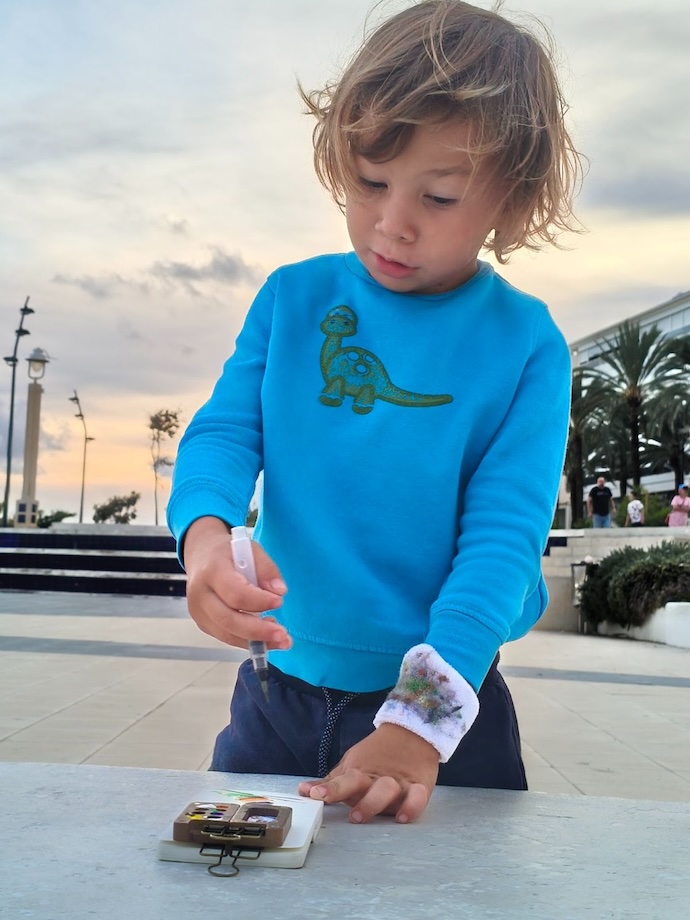 kid with mini art pad