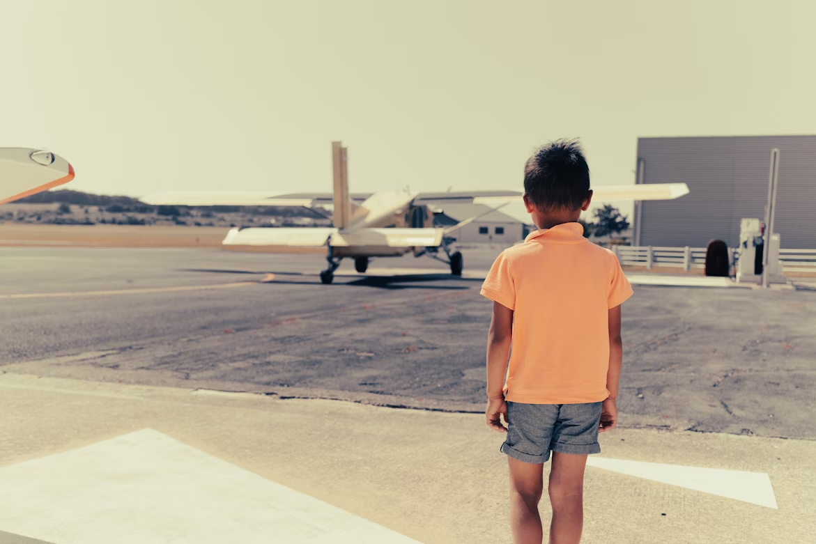 Small boy heading towards plane