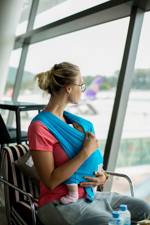 WOMAN WITH BABY AT AIRPORT