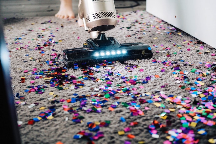 vacuuming a mess of glitter on carpet