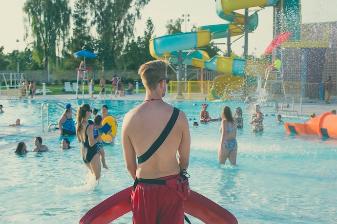 a lifeguard watches a waterpark