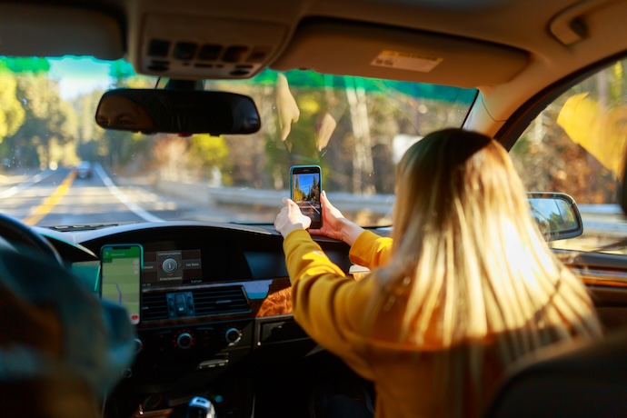kid taking photo in car