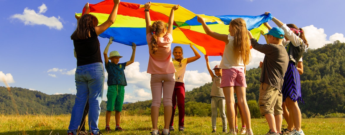 a group of children play a flag game outdoors