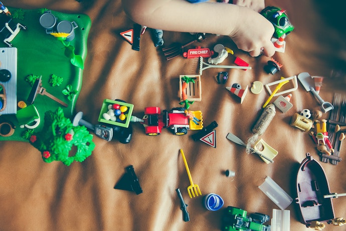 a child plays with small toys