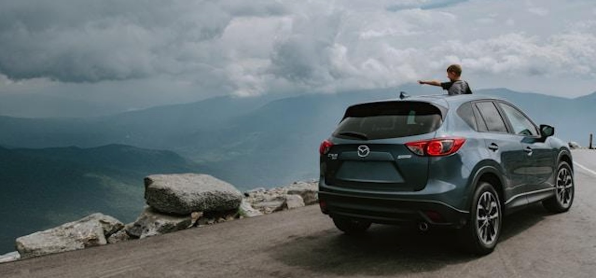kid staring out of car into the landscape
