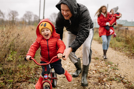 A small child enjoying a bike ride 