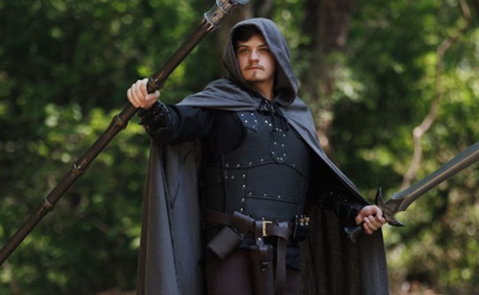 Cloaked fantasy warrior with staff and sword