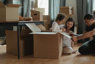 Family packing boxes to move home