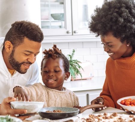 a young family enjoy cooking together