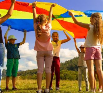 a group of children play a flag game outdoors