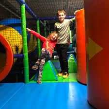 children having fun in indoor play